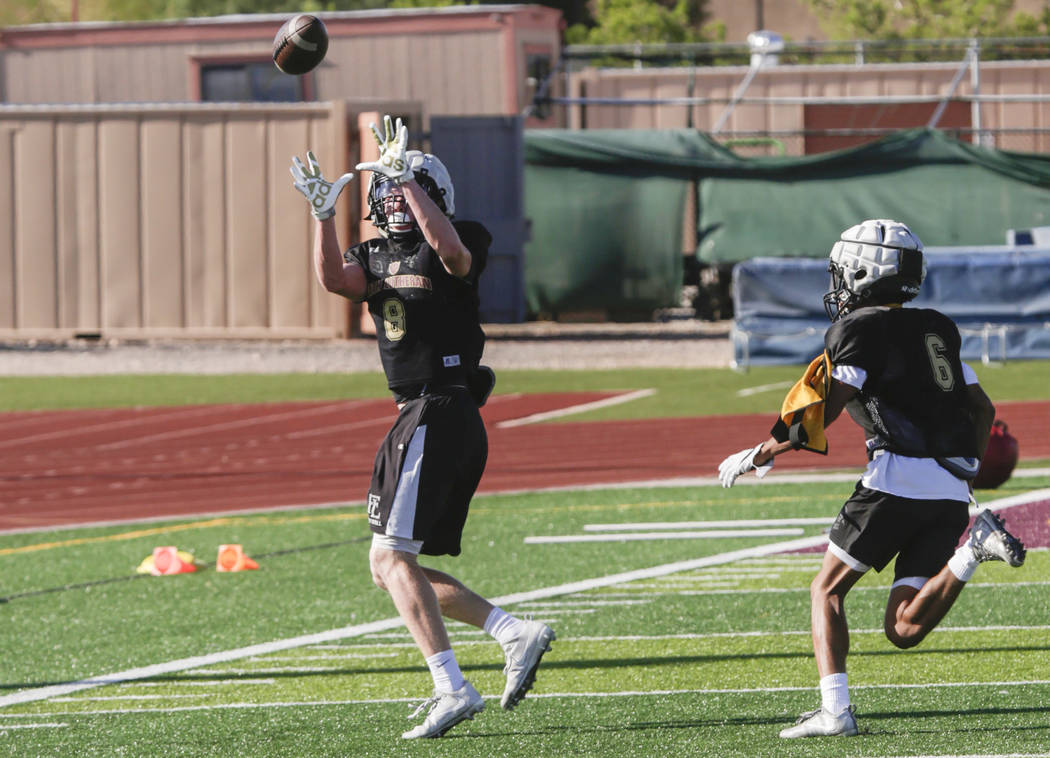 Faith Lutheran wide receiver Elija Kothe (8) catches a pass after bypassing corner back Myle ...