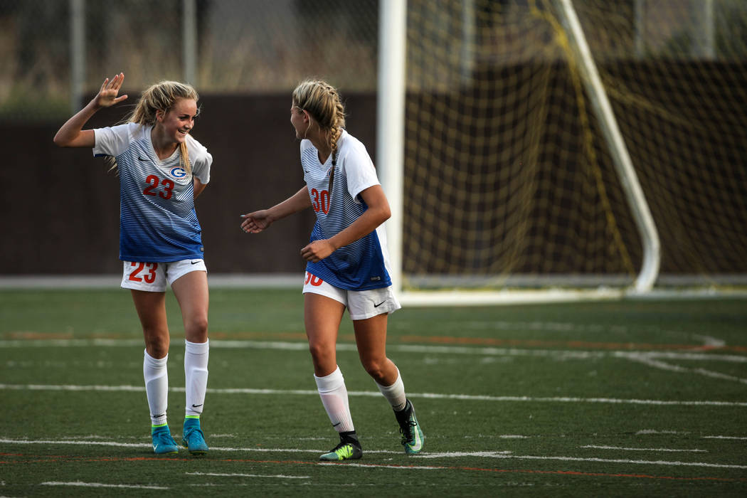 Bishop Gorman’s Jacqueline Hillegas, 23, celebrates with Gianna Gourley, 30, after sco ...