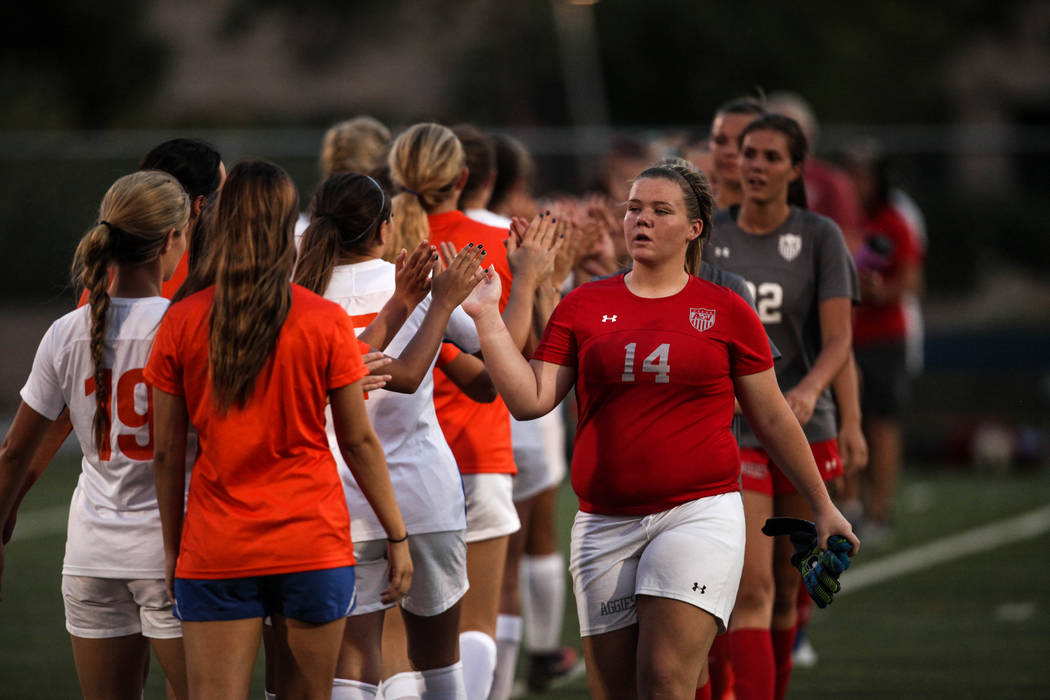 Arbor View’s Krystin Cooper, 14, high fives players from Bishop Gorman after losing 4- ...