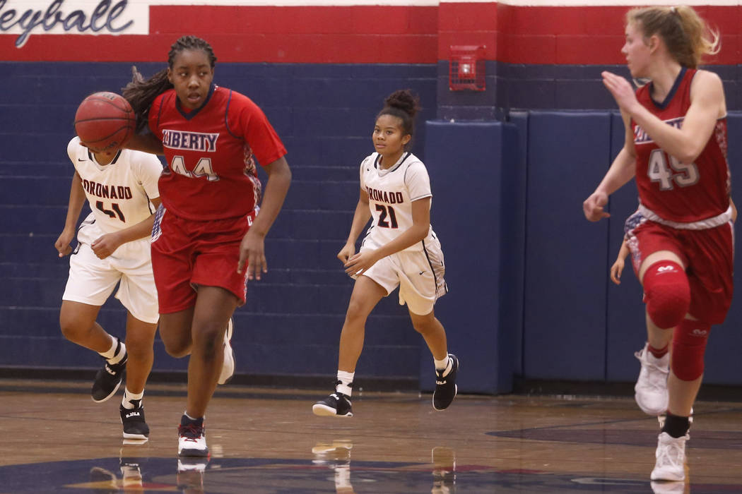 Liberty junior Dre’una Edwards (#44) drives down the court during a basketball game on ...