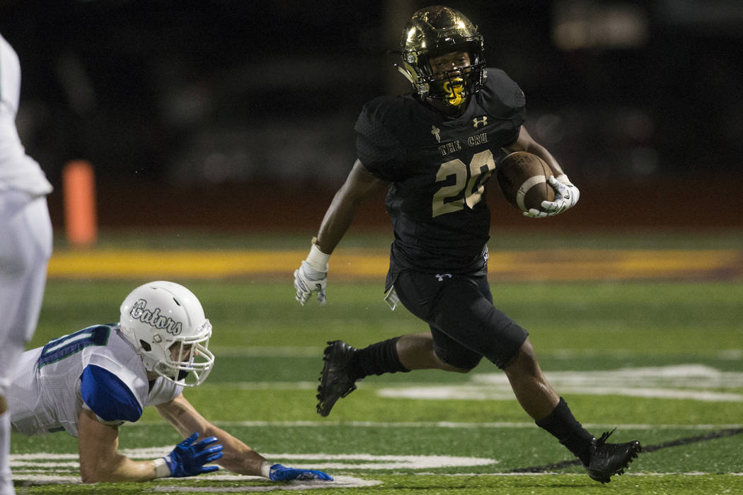 Faith Lutheran’s Saundre Spiller (20) runs the ball against Green Valley in the footba ...