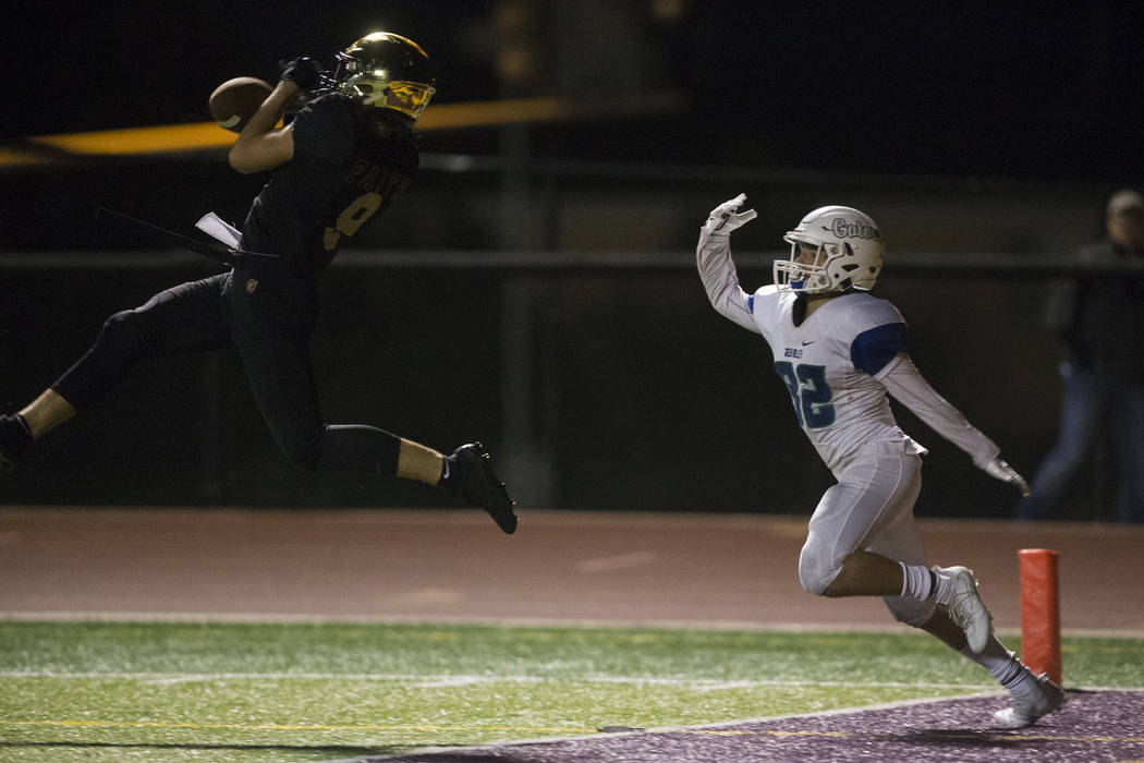 Faith Lutheran’s Keagan Touchstone (9) deflects a pass to Green Valley’s Braxton ...
