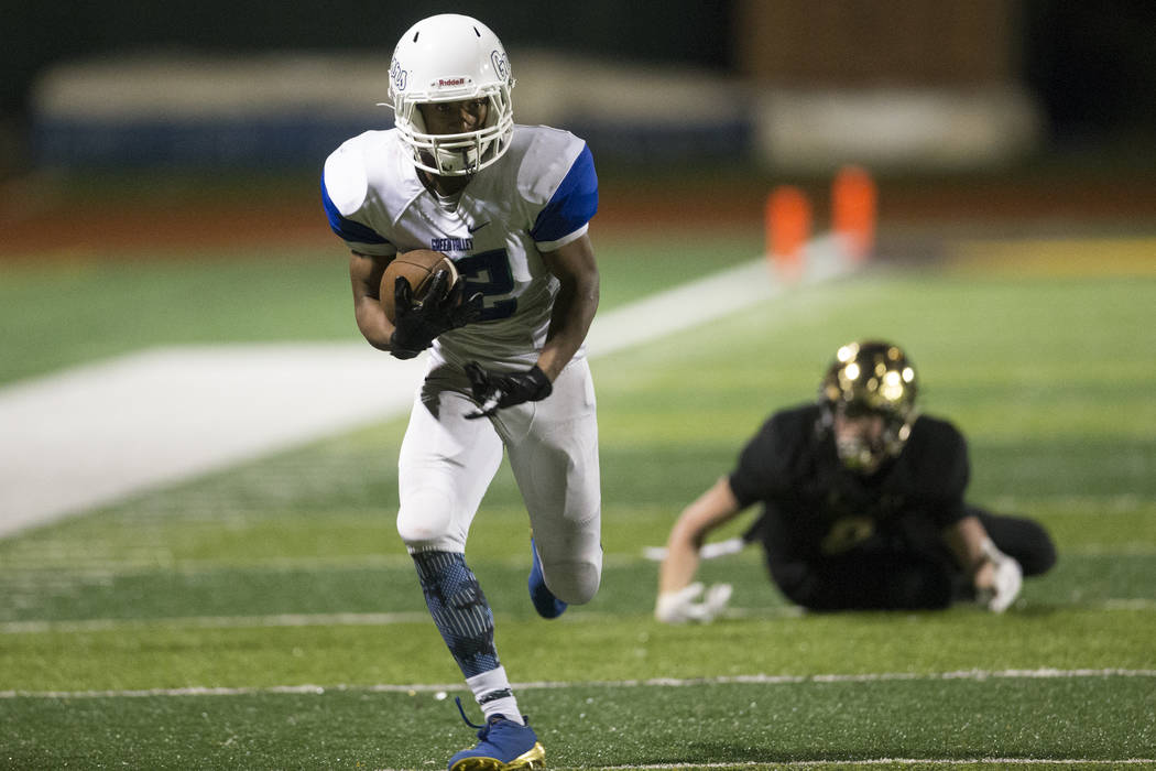 Green Valley’s Israel Robinson (12) runs the ball after an interception against Faith ...
