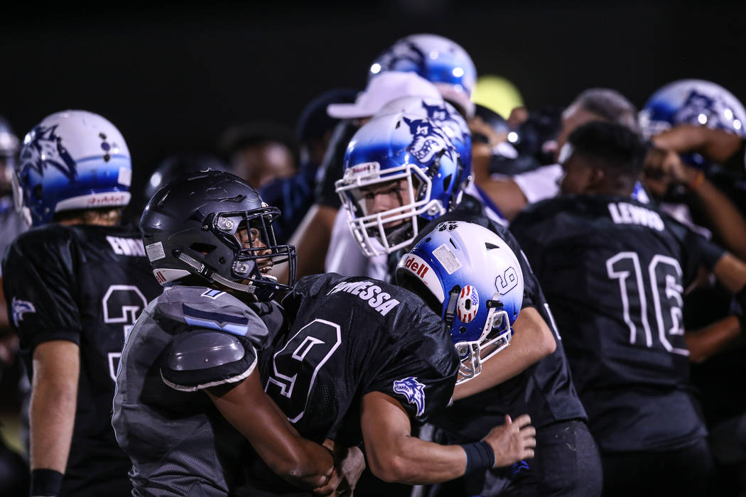 Canyon Springs’ Johnathan Bailey (7) fights Basic’s Daniel Paonessa (9) as a bra ...