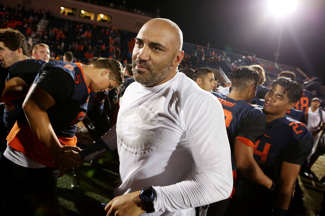 Bishop Gorman head coach Kenny Sanchez, center, shakes hands with players after their 34-7 w ...