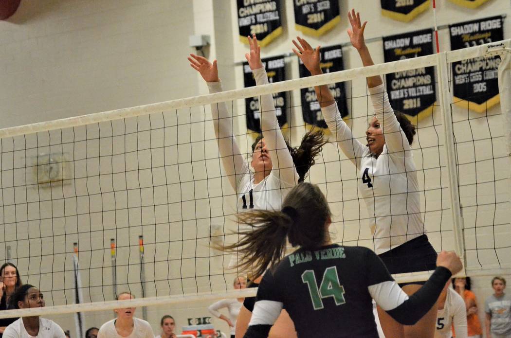 Shadow Ridge’s Natalie Nihipali (11) and Kizzy Rodriguez (4) sky for a block, as Palo ...