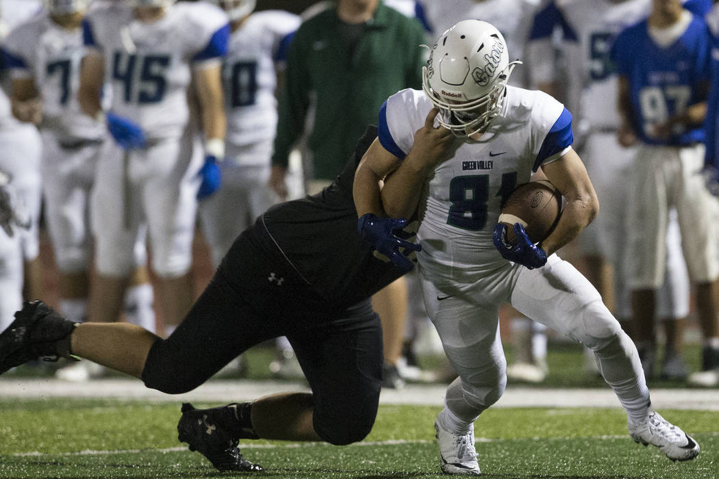 Faith Lutheran’s Jacob Freel (72) tackles Green Valley’s Reyden Morett (81) in t ...