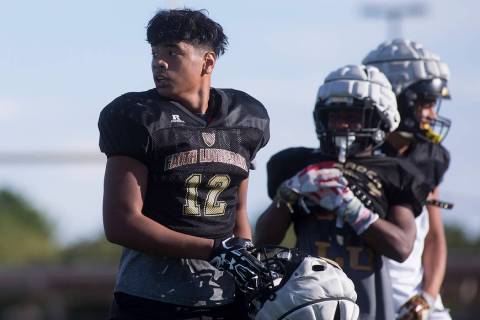 Faith Lutheran football player Ma’a Gaoteote takes off his helmet for a water break du ...