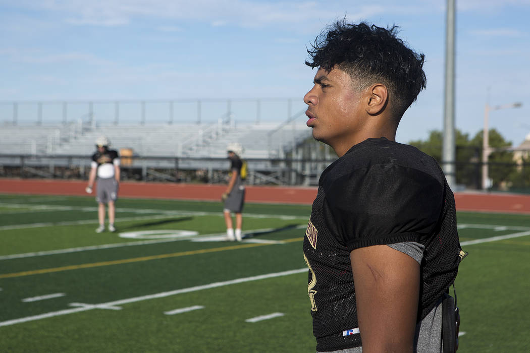 Faith Lutheran football player Ma’a Gaoteote takes off his helmet for a break between ...