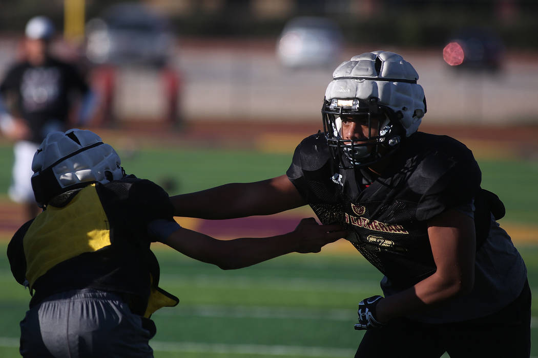 Faith Lutheran football player Ma’a Gaoteote, right, practices with teammates at Faith ...