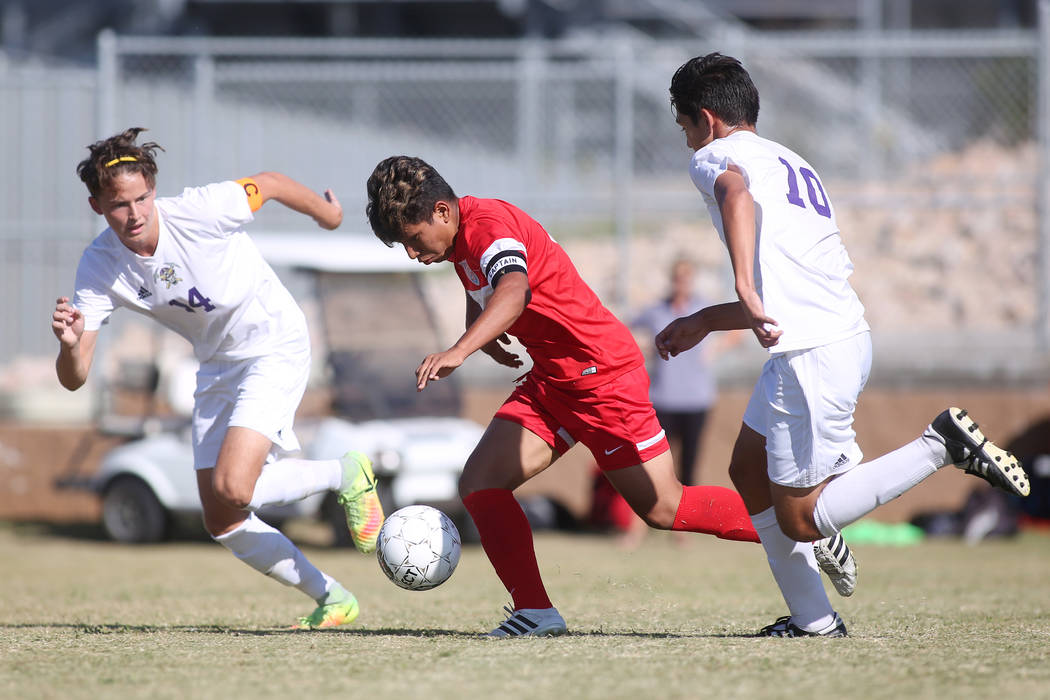 Sunrise Mountain players Julian Herrera (14) and Angel Arreola (10) chase after Western play ...