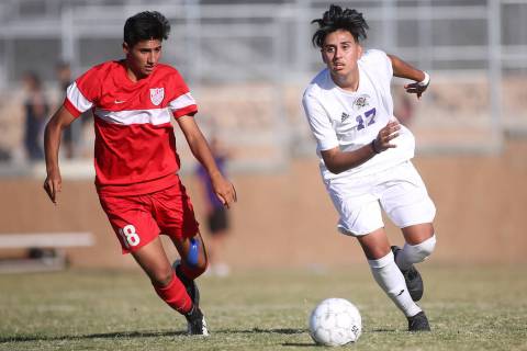 Western player Hector Riquelme (18) chases after Sunrise Mountain player Bryan Garcia (17) w ...