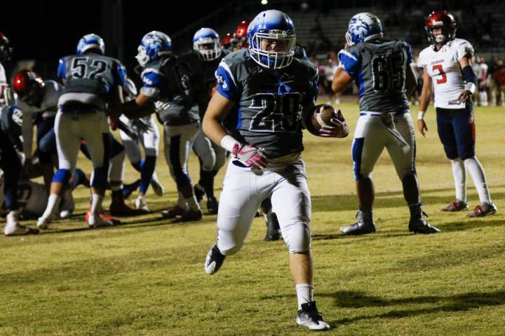 Basic’s Trace Evans (34) scores a touchdown against Coronado during a football game at ...