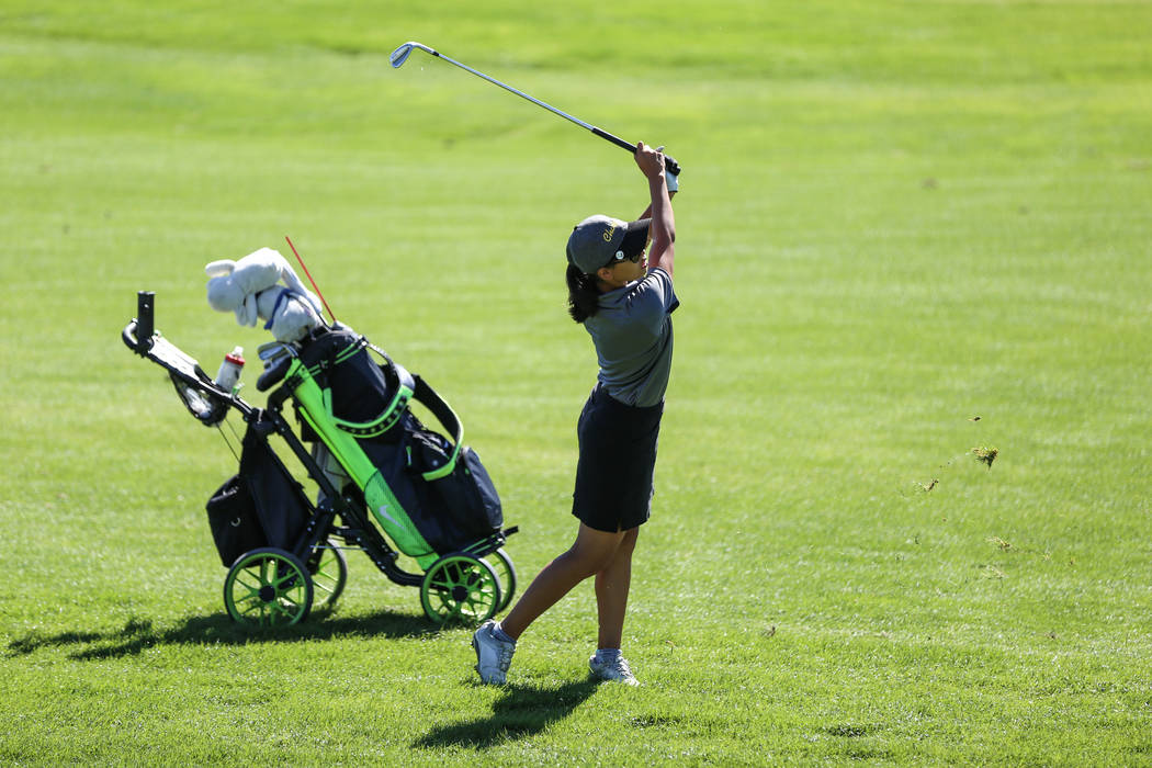 Clark’s Riana Mission swings during the Class 4A Sunrise and Sunset Region girls golf ...
