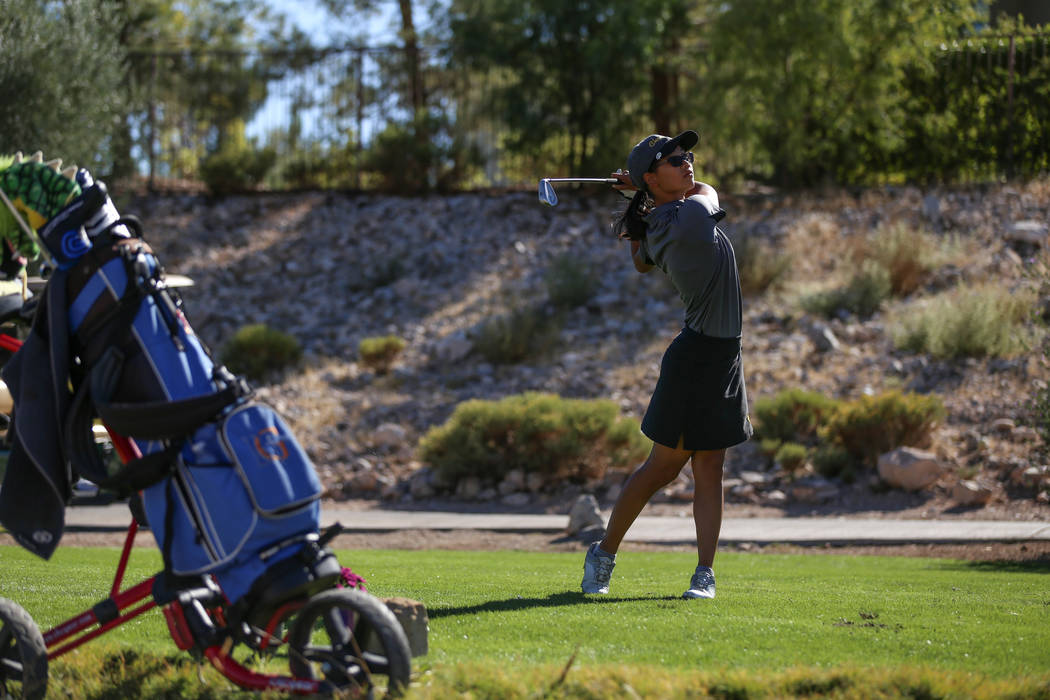 Clark’s Riana Mission swings during the Class 4A Sunrise and Sunset Region girls golf ...