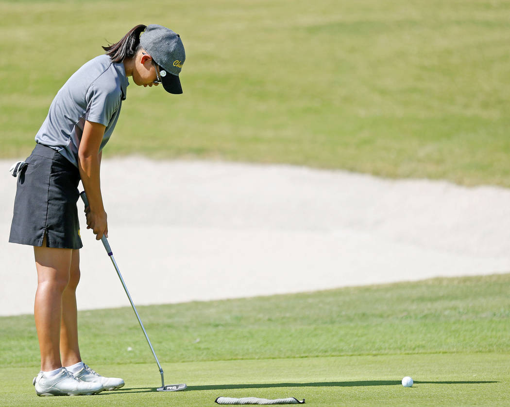 Clark high school’s Riana Mission putts on hole six during the 4A State Golf Champions ...