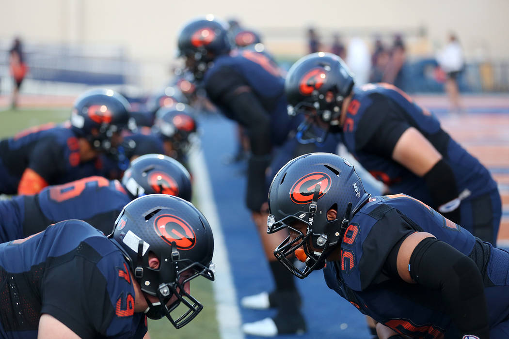 Bishop Gorman players Duncan Goodrich (79) and Jordan Cabradilla (50) warm up prior to the s ...