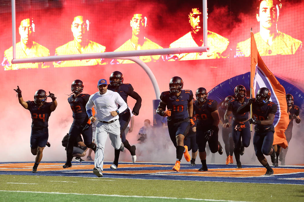 Bishop Gorman head coach Kenny Sanchez runs onto the field with his players prior to the sta ...