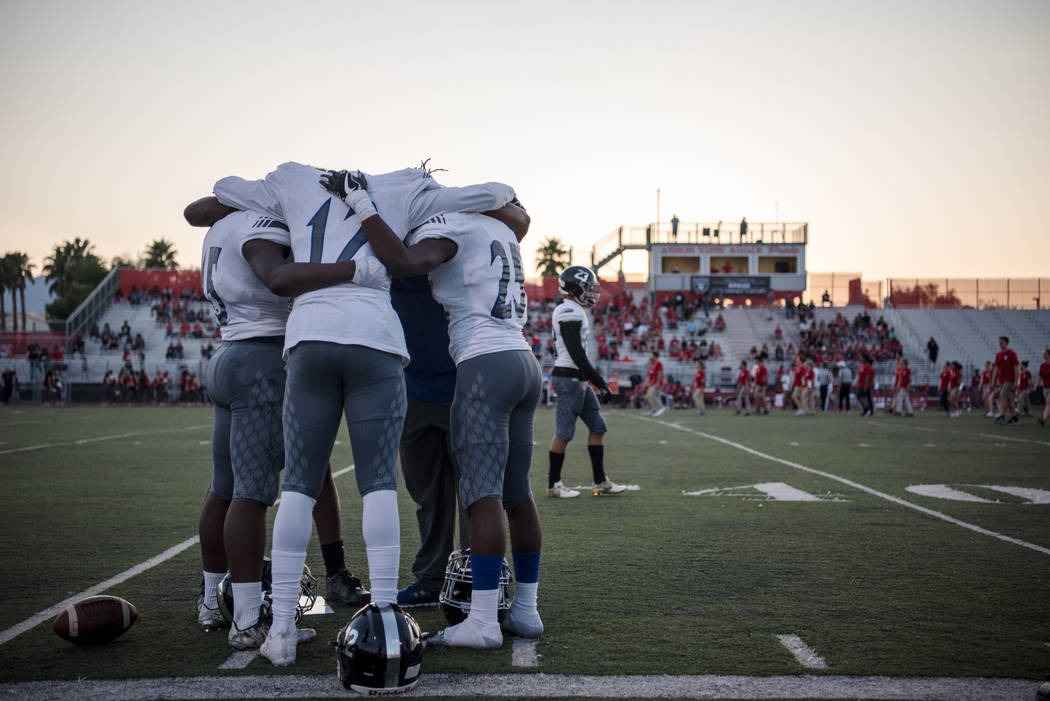 Desert Pines football players pray before the game at Arbor View High School on Friday, Sep. ...