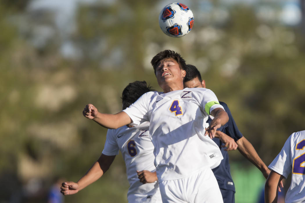 Durango’s Gael Delangel-Parra (4) leaps for the ball in the playoff soccer game agains ...