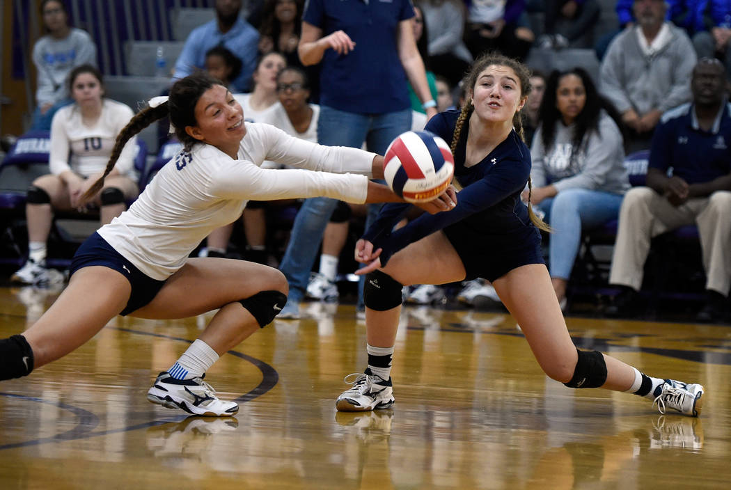 Shadow Ridge’s Kizzy Rodriguez, left, and Braedyn Peters dig for the ball against Bish ...