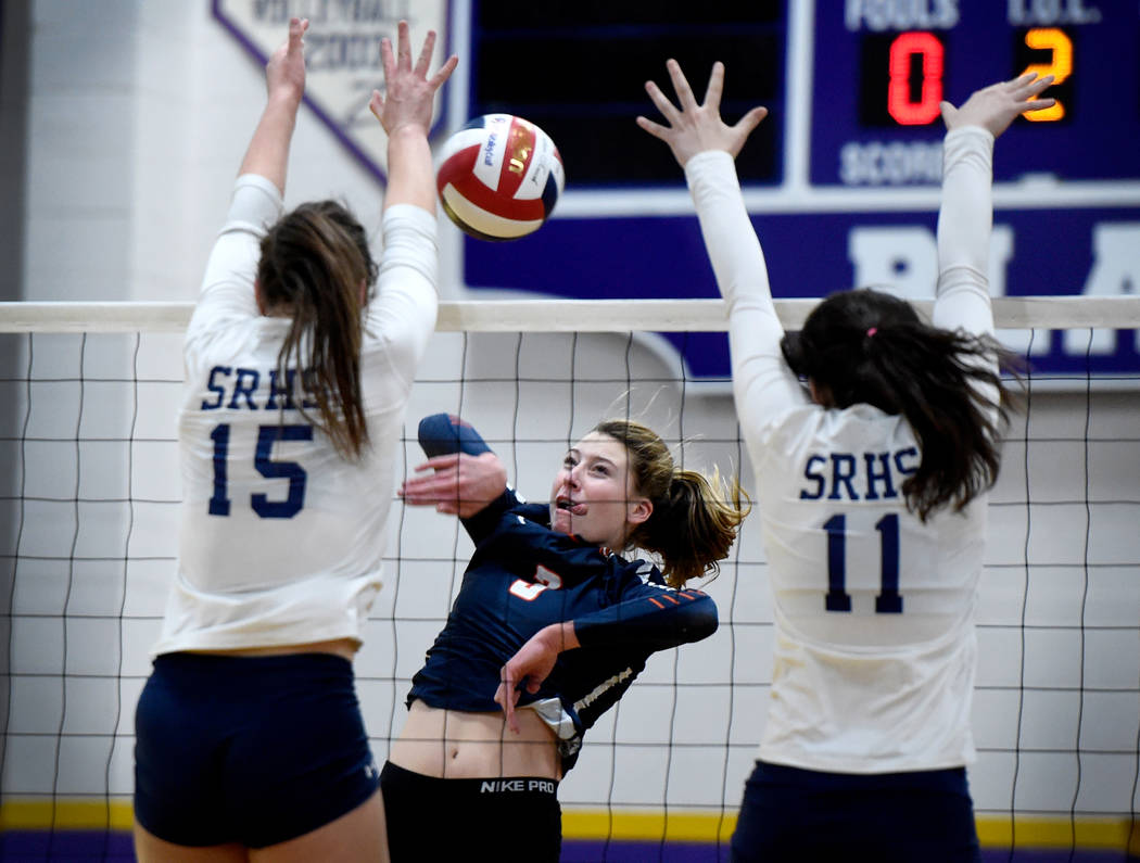 Bishop Gorman’s Tommi Stockham, center, hits the ball against Shadow Ridge’s Whi ...