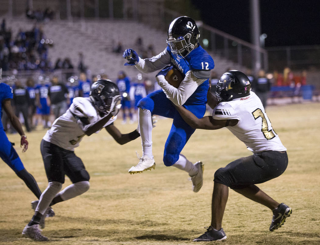 Desert Pines running back Jyden King (12) jumps into the end zone for a touchdown during the ...
