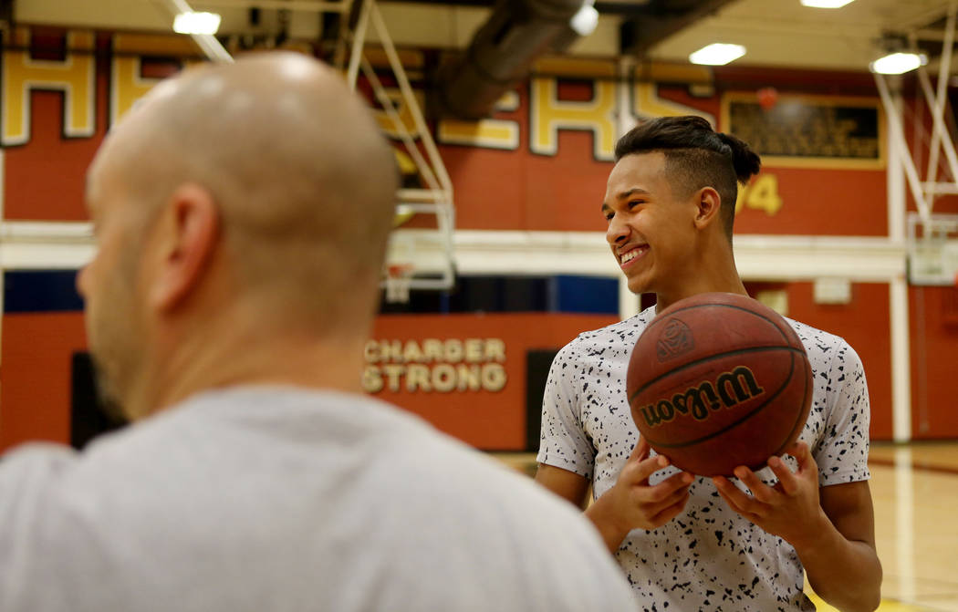 Clark High School senior Greg Foster speaks with coach Chad Beeten during basketball practic ...