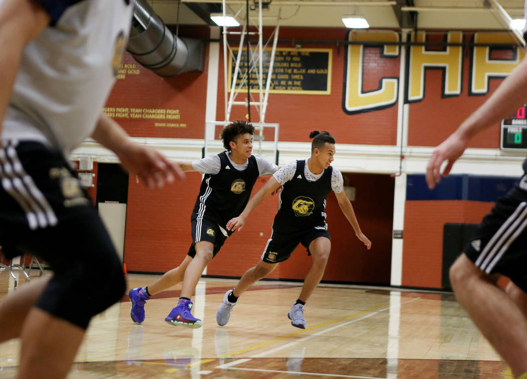 Jalen Hill, left, and Greg Foster, participate in drills during basketball practice at Clark ...