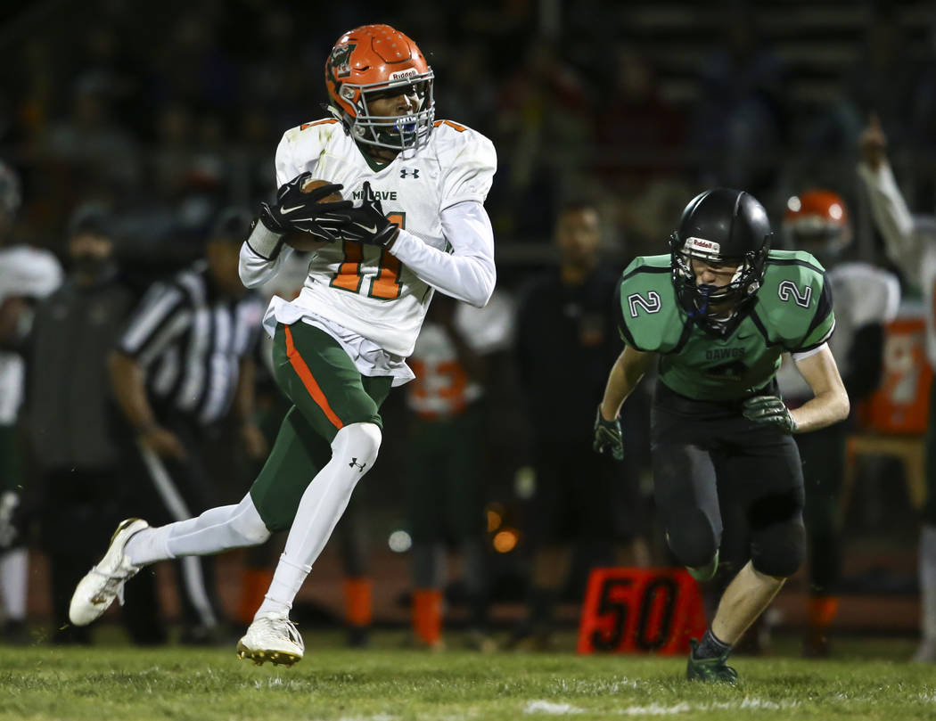 Mojave’s John Harper (11) runs the ball past Virgin Valley’s Easton Jensen (2) d ...