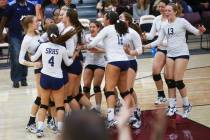 Shadow Ridge players celebrate after defeating Coronado in the Class 4A state volleyball gam ...