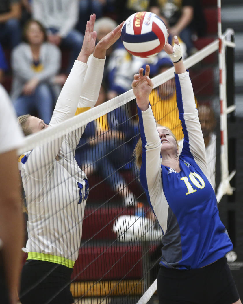 Lowry’s Brittany Jacaway (12) blocks a shot from Moapa Valley’s Aria Messer (10) ...