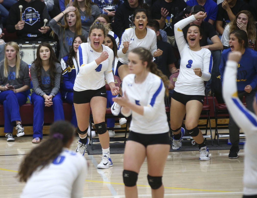 Lowry players celebrate while playing Moapa Valley during the Class 3A state volleyball game ...