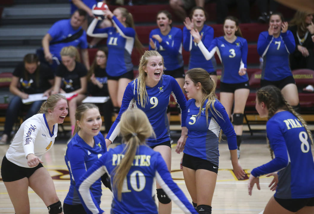 Moapa Valley players celebrate while playing Lowry during the Class 3A state volleyball gam ...