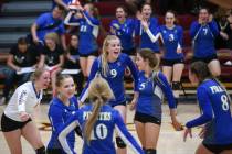 Moapa Valley players celebrate while playing Lowry during the Class 3A state volleyball gam ...