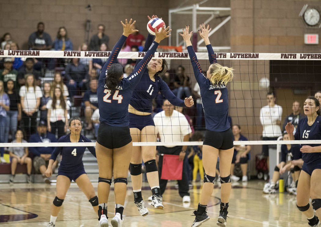 Shadow Ridge’s Kahea Nihipali (11) spikes against Gorman’s Alex Washington (24) ...