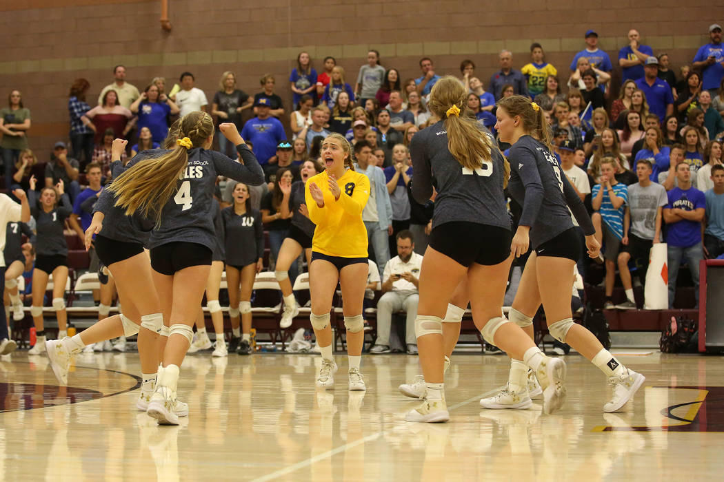 Boulder City teammates celebrate a point over Moapa Valley during the class 3A state volleyb ...