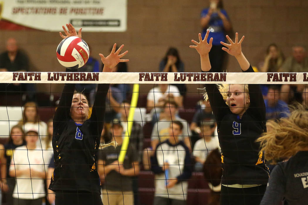 Moapa Valley teammates Shelbi Walker (8) and Eden Whitmore (9) attempt to block Boulder City ...