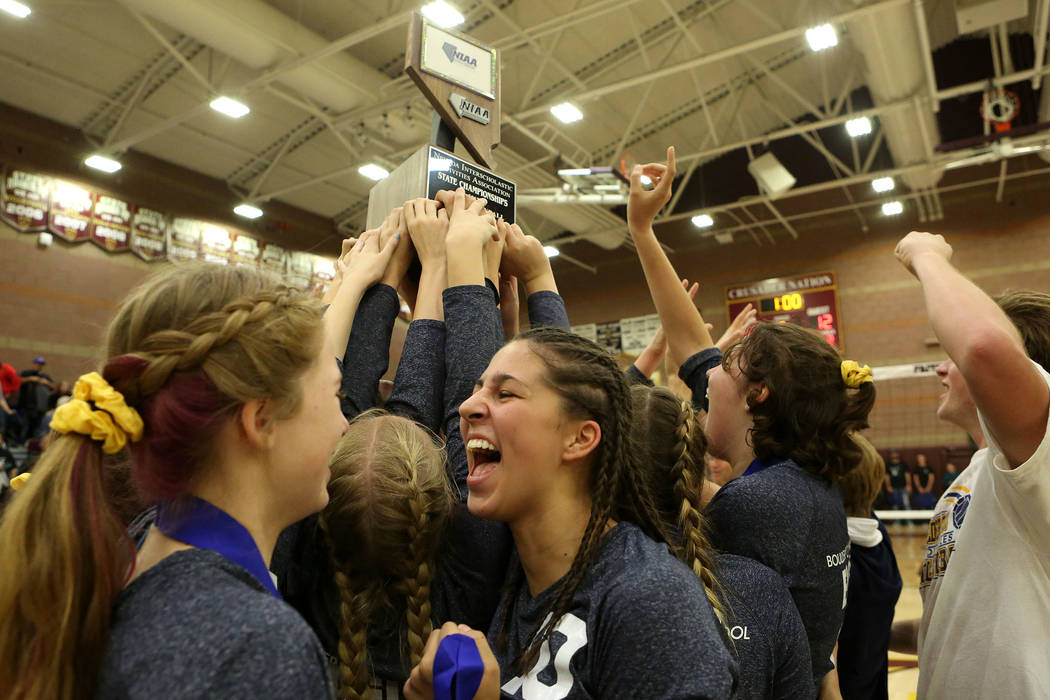 Boulder City teammates hold up their trophy as they celebrate their 3-2 win over Moapa Valle ...
