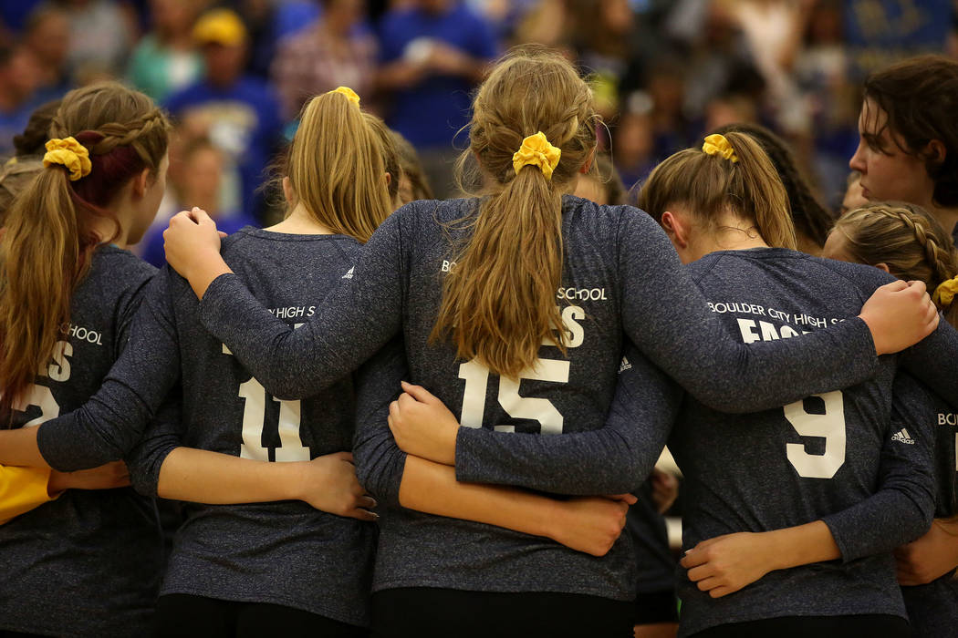 Boulder City teammates huddle between sets during the class 3A state volleyball championship ...