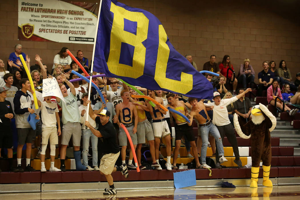 Bob Cox runs a &quot;BC&quot; flag in front of the Boulder City student section duri ...