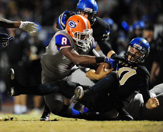 Bishop Gorman defensive end Adam Plant Jr. (8) sacks Sierra Vista quarterback Oscar Aliaga i ...