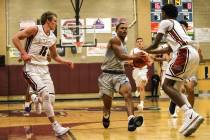 Canyon Springs’ Kevin Legardy (4), center, dribbles the ball against Desert Oasis befo ...
