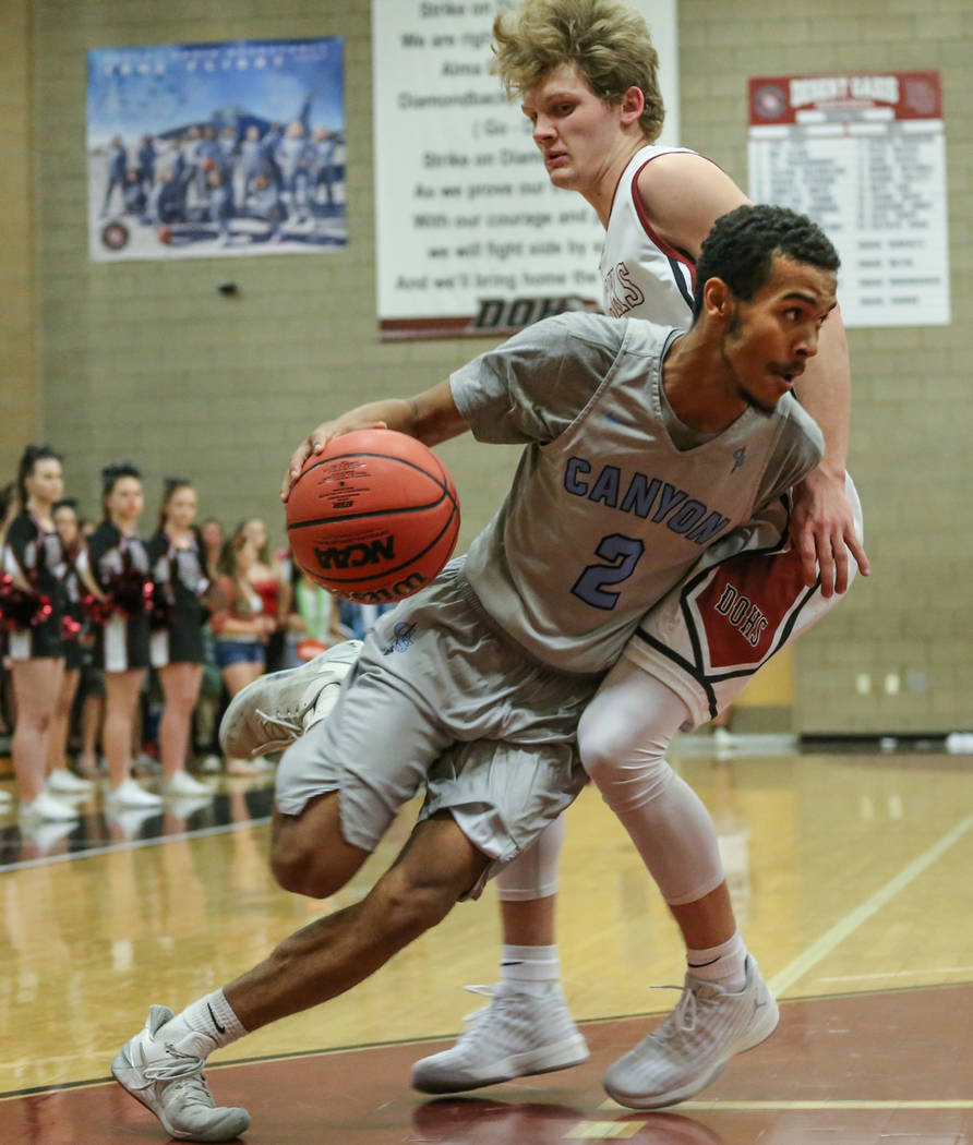 Canyon SpringsՠAlexander Spaight (2), left, dribbles the ball as he is guarded by Dese ...