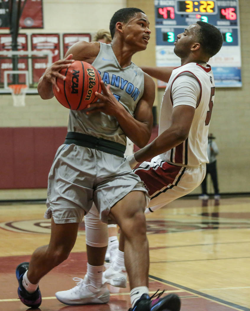 Canyon SpringsՠKevin Legardy (4), center, carries the ball as he knocks down Desert Oa ...