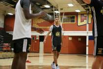 Clark High School senior Greg Foster, center, finishes a drill during basketball practice at ...