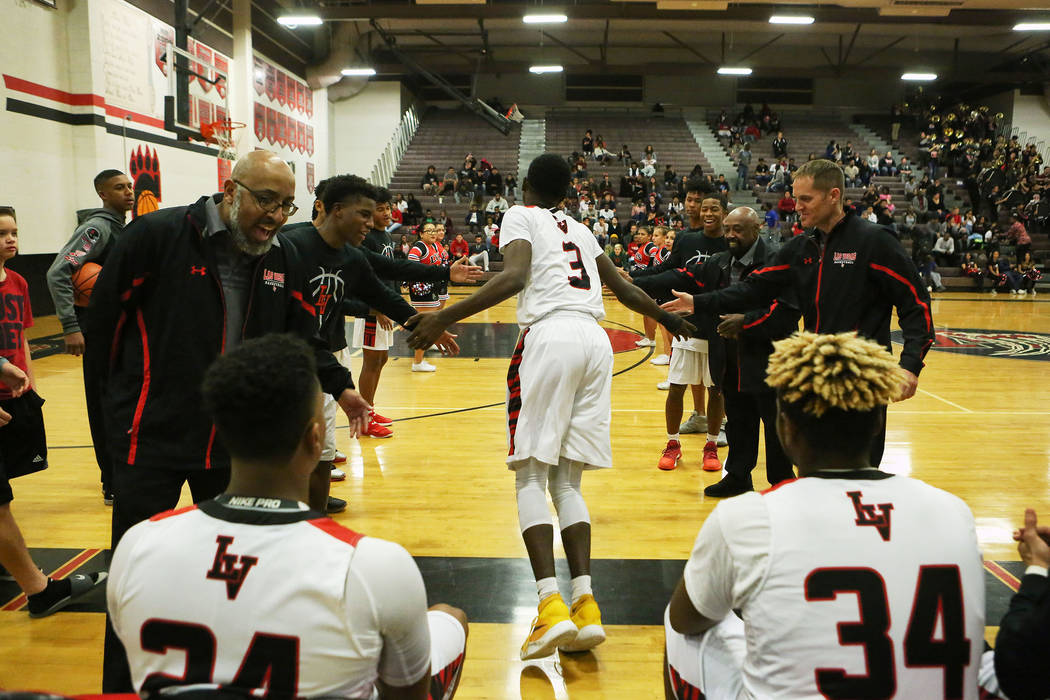 Las Vegas players welcome Kiaeem Johnson-Gonzaque (3) to the court prior to their game again ...
