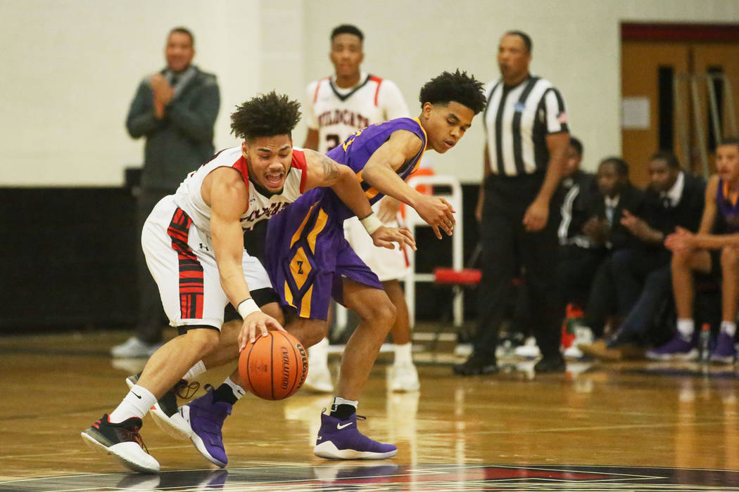 Las Vegas player Donovan Joyner (12) and Durango player Anthony Hunter (21) fight for the ba ...