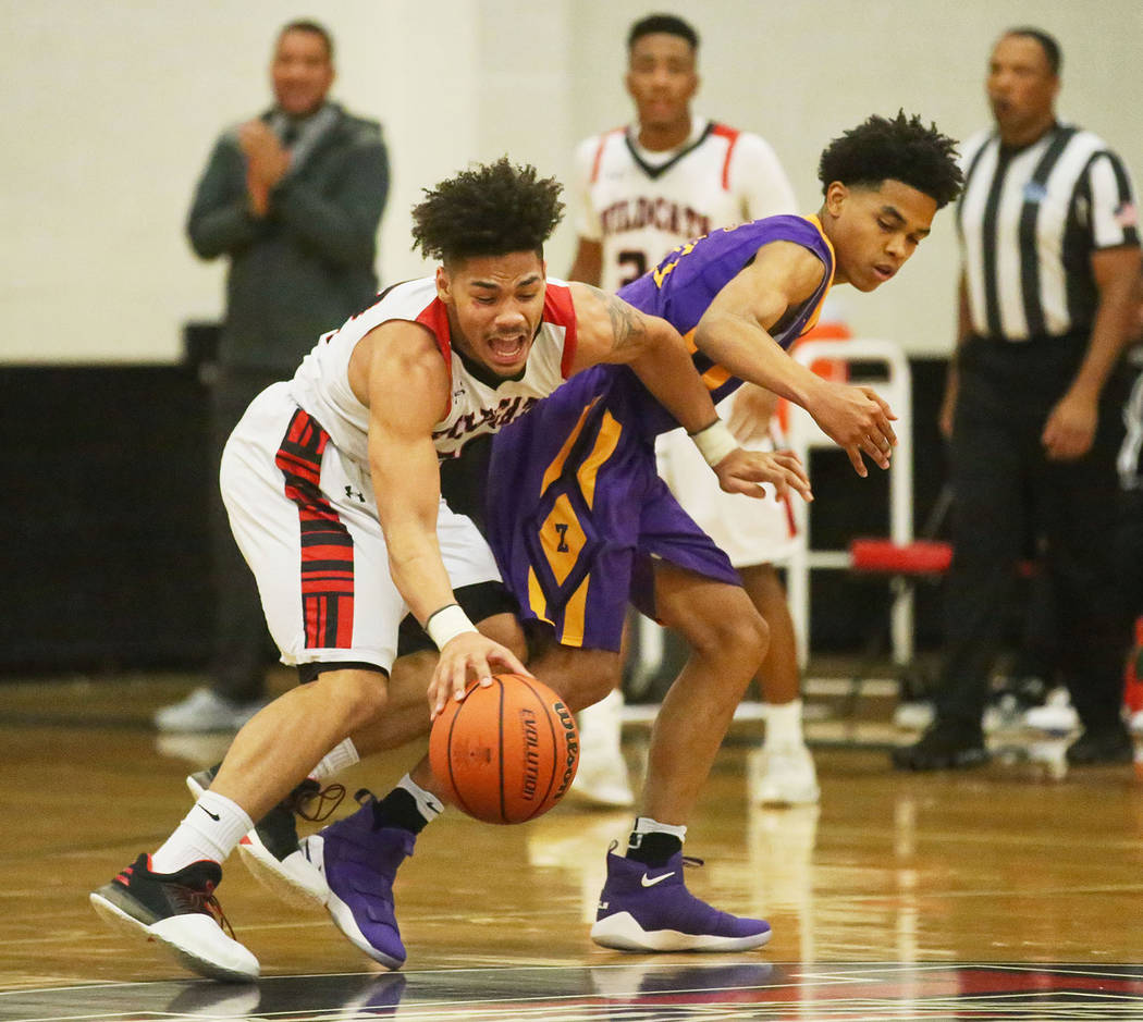 Las Vegas player Donovan Joyner (12) and Durango player Anthony Hunter (21) fight for the ba ...