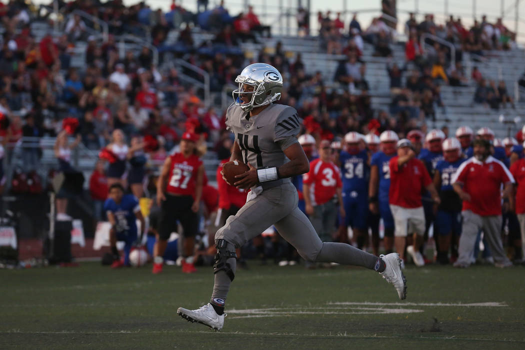 Bishop Gorman player Dorian Thompson-Robinson (14) runs the ball during the class 4A state s ...